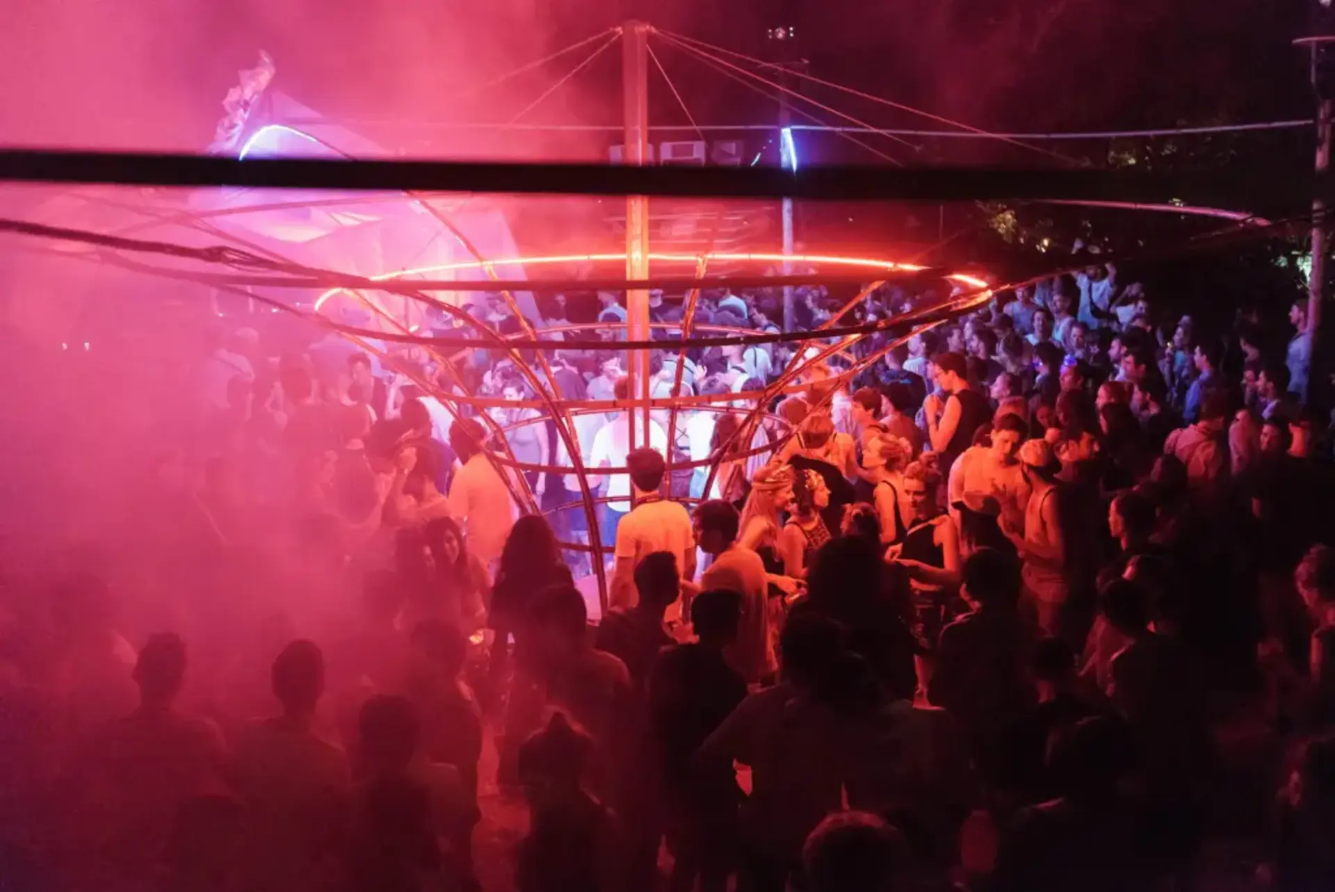 Red-lit dancefloor with dancers